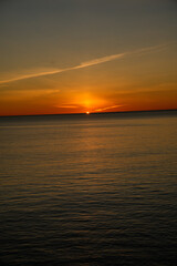 Fototapeta premium Golden sunset reflecting on calm ocean water surface