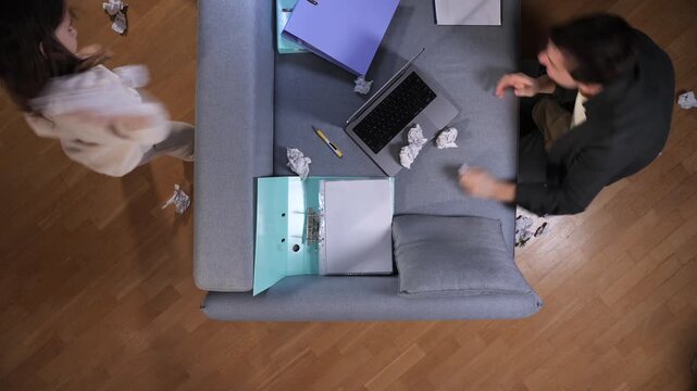 father and daughter enjoying a fun paper fight during a work break at home, finding joy while balancing professional responsibilities and family time