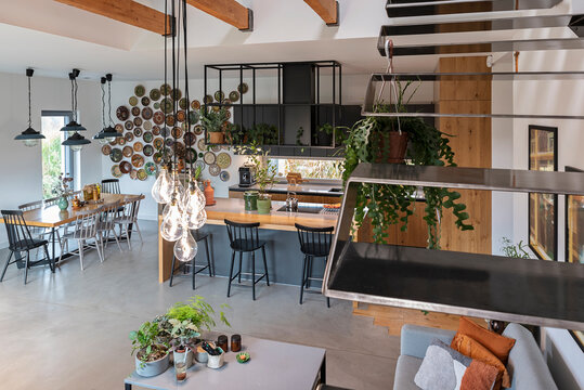 Home interior with metal stairs in electic style. Modern living room in modern house. Indoors architecture. Home decor and Real estate.