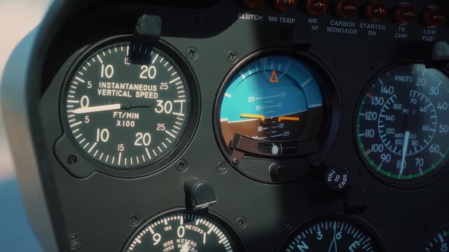 Instrument panel of a helicopter cockpit showing vertical speed indicators and altimeter readings, with gauges transitioning from low to high values in a clear sky setting