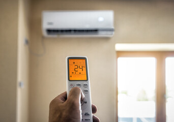 A remote control of air conditioner in human hand