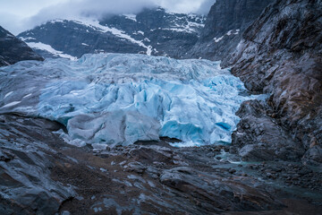 Nigardsbreen Glacier with Blue Ice and Rocky Valley in Norway