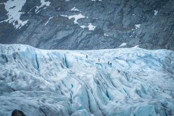 Hikers Walking on Nigardsbreen Glacier in Norway