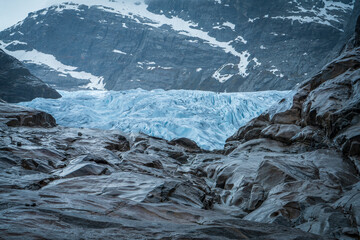 Nigardsbreen Glacier with Blue Ice and Rocky Valley in Norway