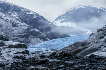 Nigardsbreen Glacier with Blue Ice and Rocky Valley in Norway