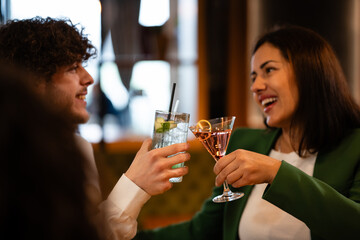 People toasting drinks celebrating friendship and socializing