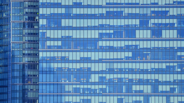 Modern office building with glass facade background. Transparent glass wall of office building.