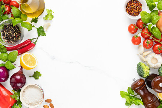 Frame of set of fresh raw ingredients for cooking delicious and healthy food on a marble background with copy space top view