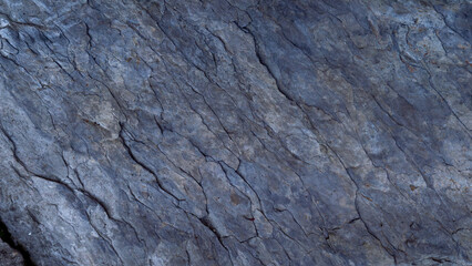 Obraz premium Cold blue stone texture with relief details, natural rock surface background