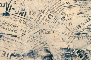 A mixed media collage of aged, yellowed newspaper fragments with blue ink smudges. Layers feature vintage typography and rough torn edges for a distressed, grungy backdrop design.