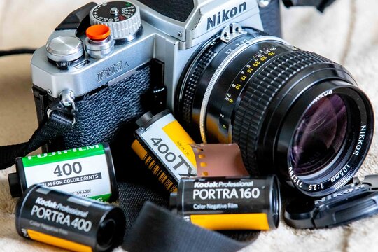 Brazil, February 7, 2026. Classic vintage Nikon FM3A analog SLR film camera with Fuji Tri-X 400 and Kodak Portra film.
