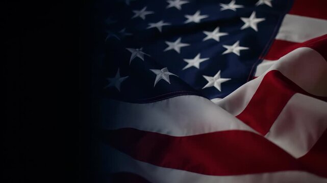 Close-up of the US flag fabric displaying stars and stripes with dramatic dark space on the left, concept for patriotic holidays, political campaigns and governmental announcements