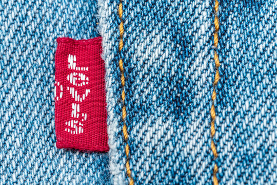 Seville, Spain; November 30, 2021: Close-up of a Levi's red tab label on denim jeans fabric with copy space.