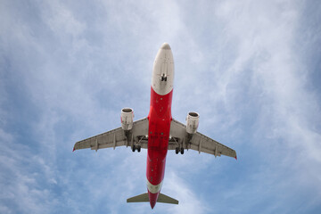 A huge passenger plane is landing in airport of Phuket, Thailand, a bottom view