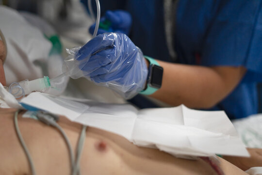 Nurse providing critical care to intubated patient in hospital