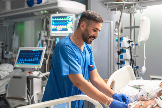 Male nurse caring patient in intensive care unit