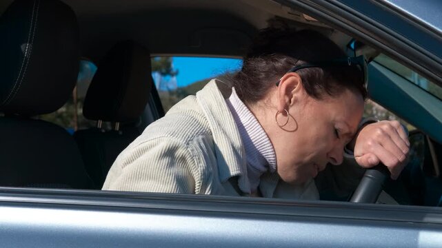 Woman suffering heart attack inside car. Mature woman sitting in her car experiencing severe chest pain and dizziness from a heart attack, eventually losing consciousness