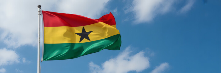 Ghana national flag proudly waving against a vibrant blue sky, a symbol of independence and...