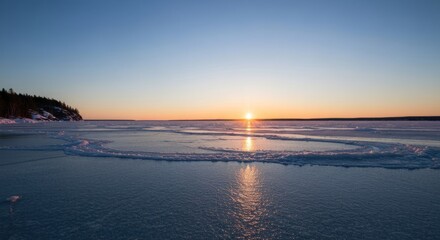 Obraz premium Frozen lake at sunset with a heart-shaped ice formation, tranquil landscape