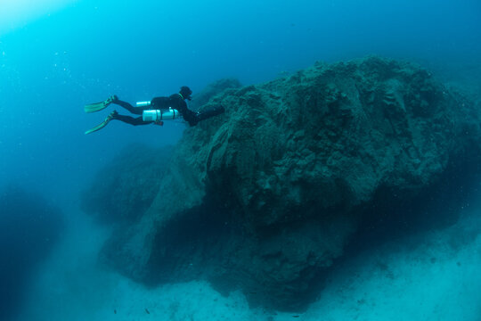 Underwater divers using DPV scooters at Palm Mar Wall dive site, Tenerife