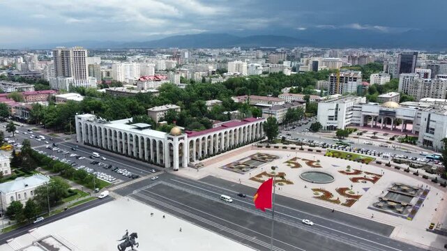 Aerial rising view of Bishkek, capitol of Kyrgyzstan, and Ala Too Square.