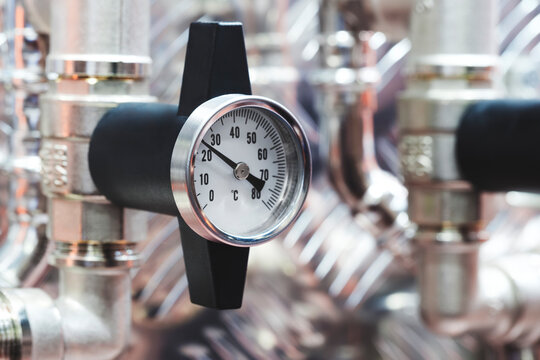 Industrial water supply gas supply machine with metal pipes and pressure gauges in industrial building, industrial background