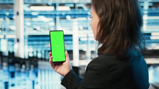 Chroma key smartphone, troubleshooting rigs issues and admin in data center. Fixing equipment computer bugs, isolated screen mobile phone and woman in server hub analyzing system logs, camera B