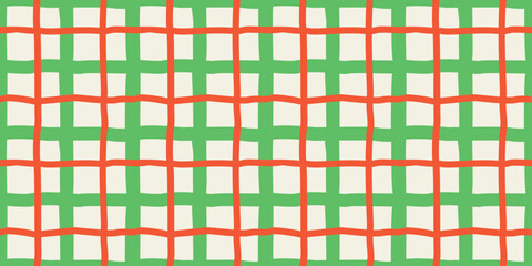 Seamless hand drawn grid pattern with irregular lines in green and orange, creating a playful geometric background for kid themed and creative designs.