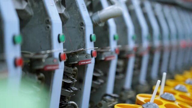 Close-up of spinning machines arranged and operating in a textile factory