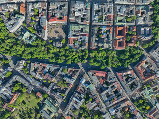 High altitude aerial view of Krakow showing dense urban districts, historic streets, green parks and mixed residential architecture in Poland