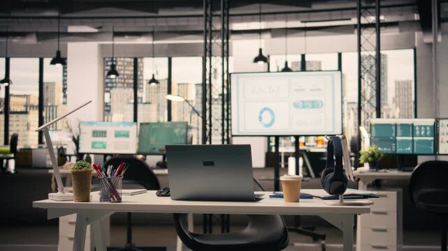 Executive office, empty, with laptop and stationery, natural light on modern furniture, business work environment. Professional corporate space, no people, urban downtown area.