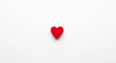 Obraz premium Minimalist red heart symbol on a clean white background, perfectly representing love and passion with ample copy space