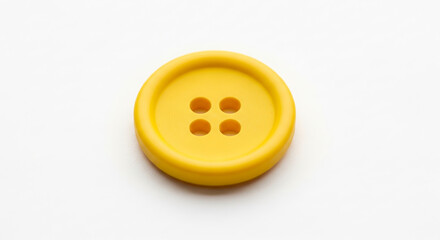 Fototapeta premium Top view of a single yellow button with four holes on a white surface, clean and isolated