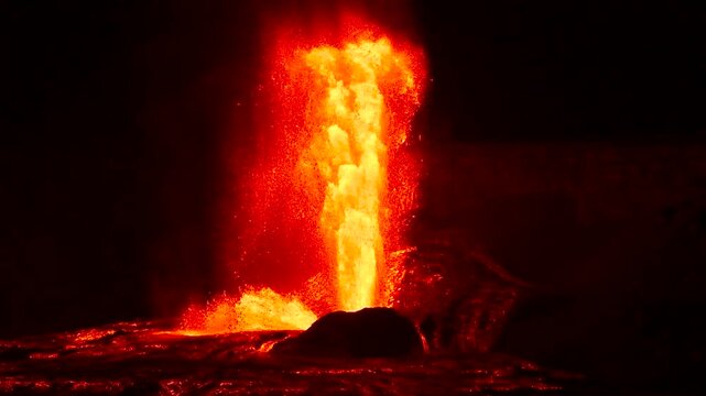 Slow motion night footage of the Kilauea volcano eruption at Halemaumau crater, with lava fountains rising up to 1000 feet in Hawaii Volcanoes National Park, Big Island, Hawaii.