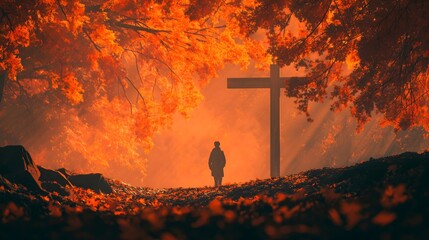 Solitary figure before a cross surrounded by fiery autumn leaves