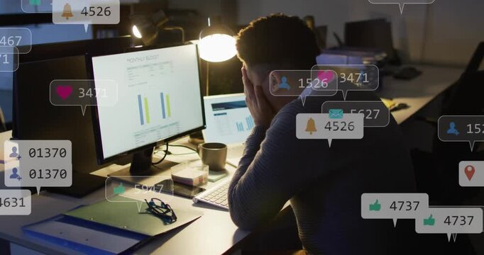 Business analyst tracking KPIs on bar charts late evening, alerts multiplying and covering desk