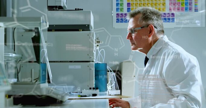 Senior scientist in lab picking vial placing sample typing and viewing overlays for analysis