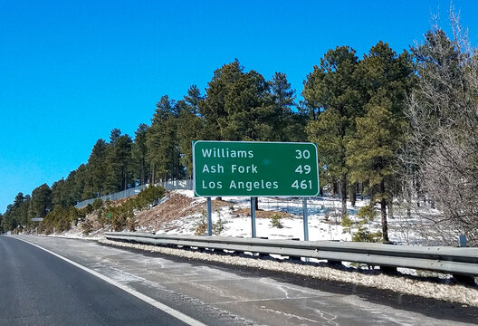 Highway Sign for Williams, Ash Fork, and Los Angeles On Interstate 40 in Arizona Winter Landscape