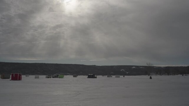 Ice fishing shacks on lake
