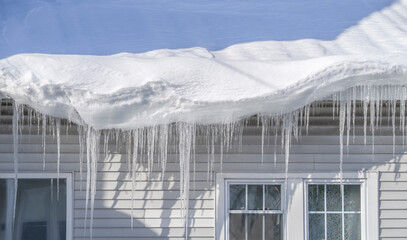 Naklejka premium winter house with icicle and snow on the roof