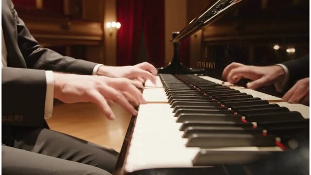 Professional pianist hands playing classical music on grand piano keys