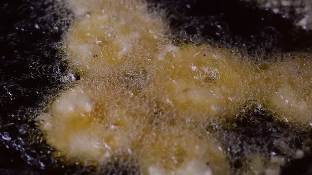 Golden Banana Slices Sizzling in Hot Oil with Crispy Sweet Treat,Banana fritter,The banana and pineapple  fritters are frying in a hot pan