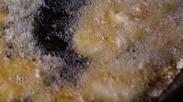 Golden Banana Slices Sizzling in Hot Oil with Crispy Sweet Treat,Banana fritter,The banana and pineapple  fritters are frying in a hot pan