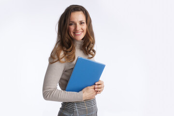 Naklejka premium A smiling woman in a beige turtleneck and plaid skirt holds a blue folder, symbolizing professional readiness, education, and modern business management.