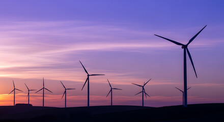 Fototapeta premium Wind turbines generating electricity at dusk with a serene landscape.
