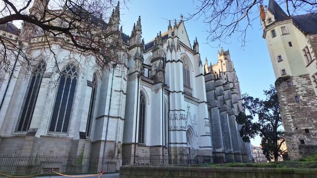 Side view of gothic Nantes Cathedral with ornate buttresses and peaked towers, Nantes, Loire-Atlantique, France