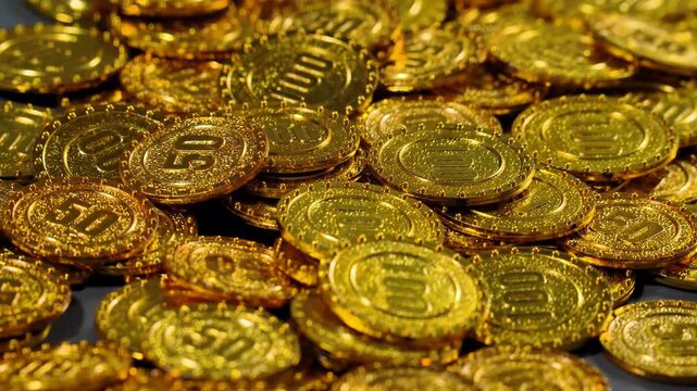 Stacks of Golden coin bills representing wealth, investment, and financial success. Much money, earned capital, wealth in the bank, treasure hoard