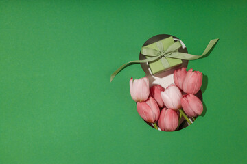 Pink tulips and a small gift create a cheerful spring scene