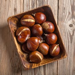 Obraz premium Roasted chestnuts fill a carved wooden bowl, presented on a textured, aged wood surface