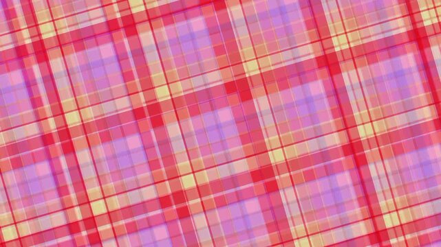 Closeup of red pink yellow plaid fabric showing a vibrant crisscross weave pattern.